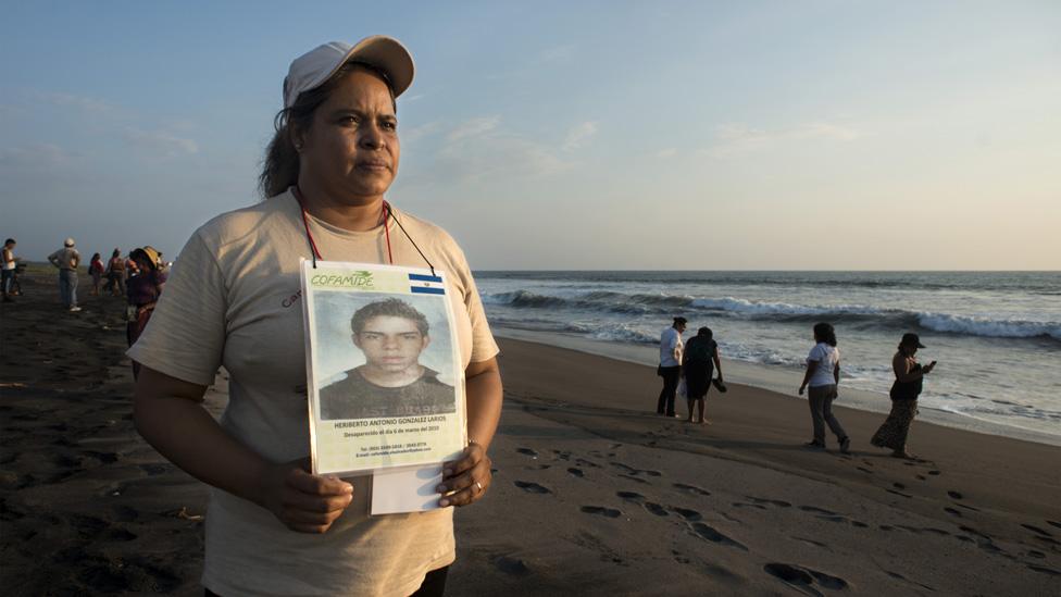 María Elena Larios holds up a picture of her son