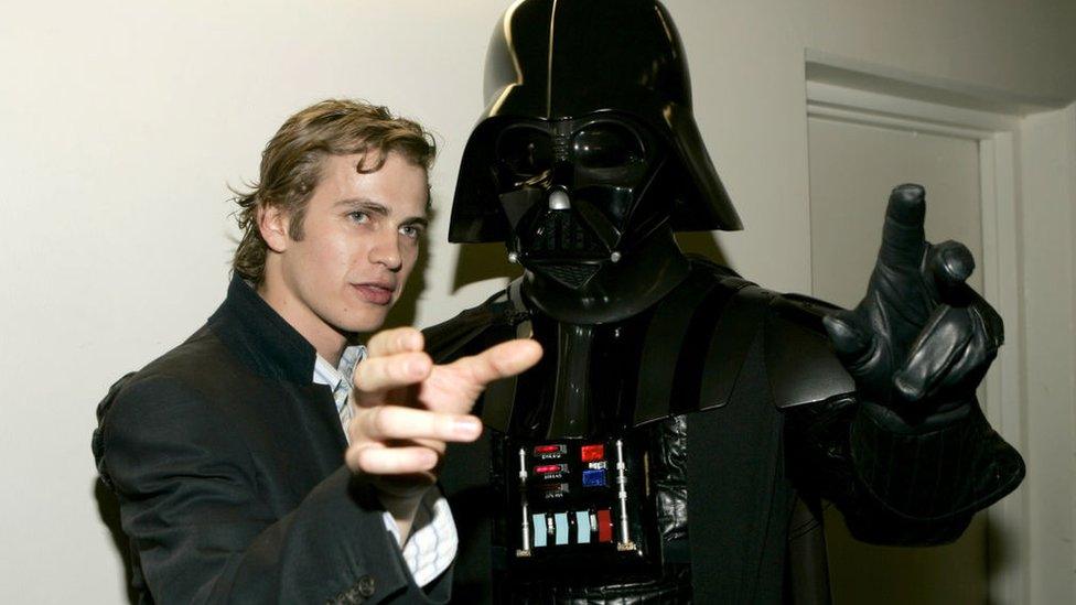 Hayden Christensen next to someone in a Darth Vader costume.