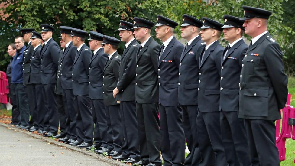 Emergency services personnel line up outside St Paul"s Church in Walkden