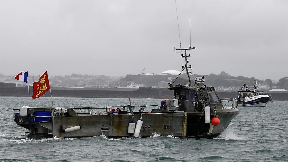 A French fishing boat, one of several, takes part in a protest in front of the port of Saint Helier off the British island of Jersey to draw attention to what they see as unfair restrictions on their ability to fish in UK waters after Brexit, on May 6, 2021