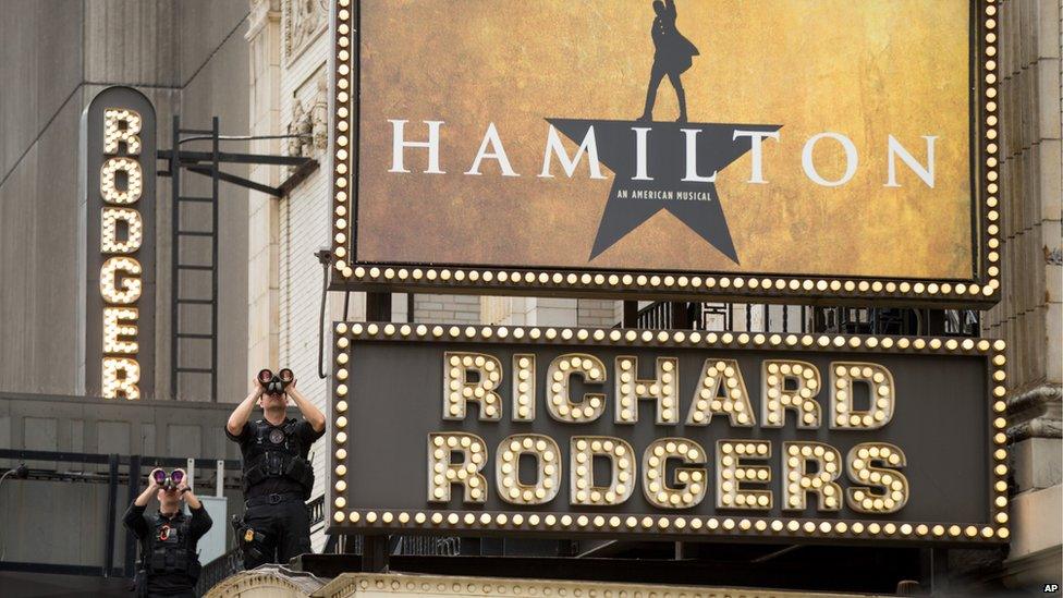 Secret Service officers stand on the awning of the Richard Rodgers Theatre in New York, Saturday, July 18, 2015,