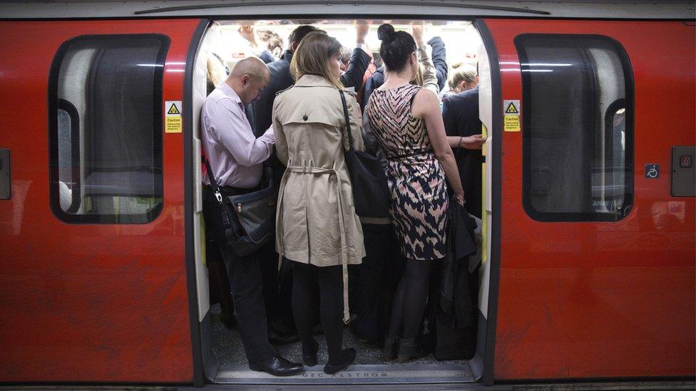 Commuters travel on a crowded Northern Line tube train of the London Underground