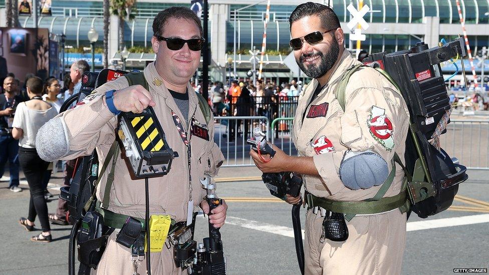 Two Comic-Con fans dressed as the original members of Ghostbusters.