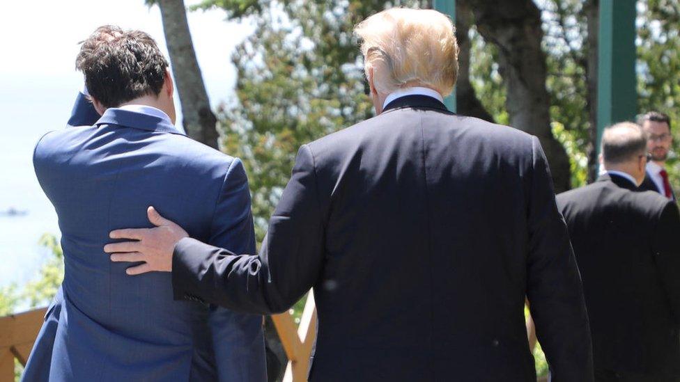 Canadian Prime Minister Justin Trudeau (L) walks with US President Donald Trump during the official G7 Summit welcoming ceremony, 8 June, 2018 in La Malbaie, Canada