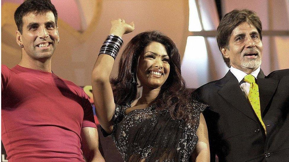 Indian movie star Amitabh Bachchan (R), Akshay Kumar (L) and actress Priyanka Chopra (C) wave during the ceremonial opening of the shooting of the film "Waqt; The Race Against Time" in Bombay, November 2003