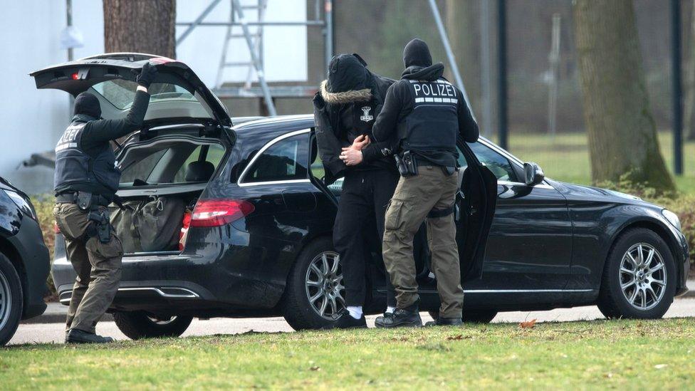 A person is brought to the Federal Supreme in Karlsruhe, Germany, by police officers, 15 February 2020