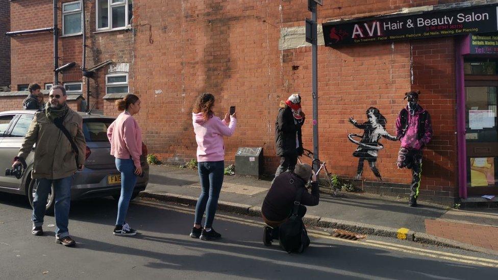 People visiting street art