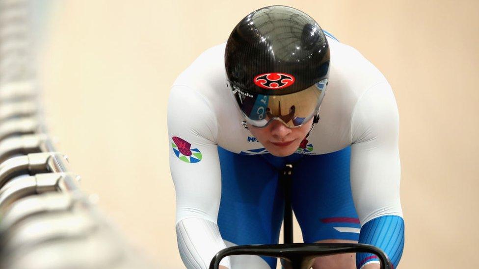 jack carlin wearing full cycling gear competing on a velodrome track