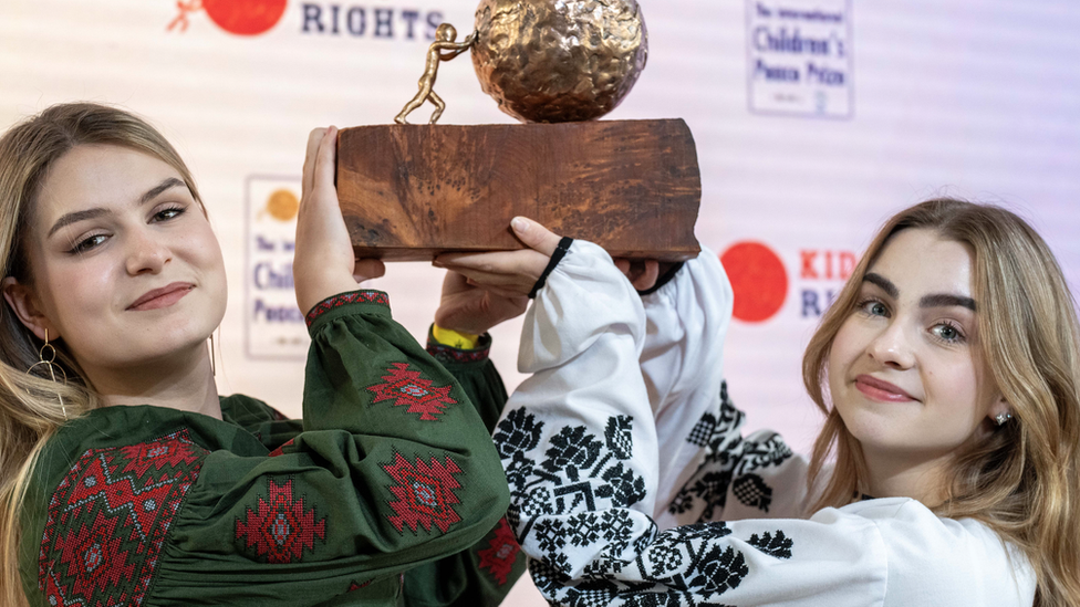 Sofia and Anastasiia holding up their prize