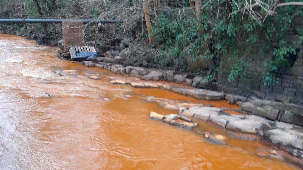 The Afon Lwyd turns orange