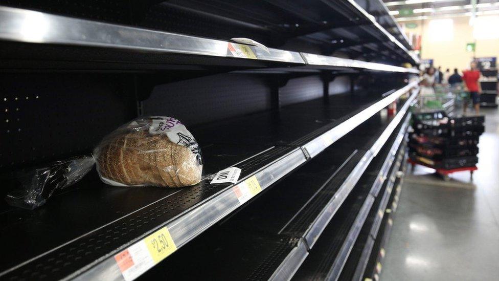 Consumers find the bread aisle at a local Walmart supermarket emptied out in Kissimmee, Florida in preparation for the landfall of Hurricane Matthew, on October 6, 2016.