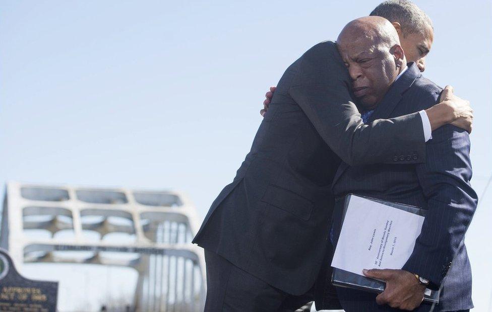 Barack Obama (L) hugs US Representative John Lewis near the Edmund Pettus Bridge in Selma