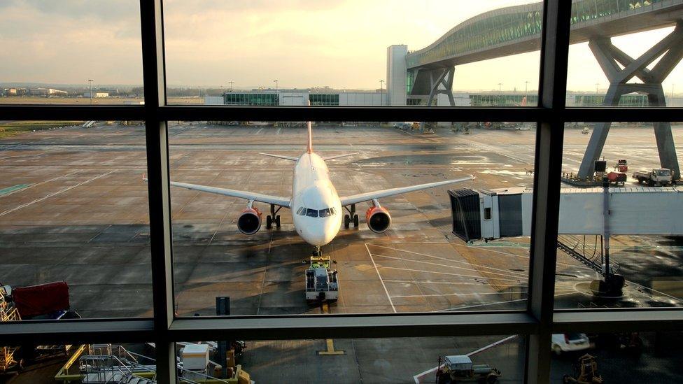 Passenger plane being refuelled in a UK airport.