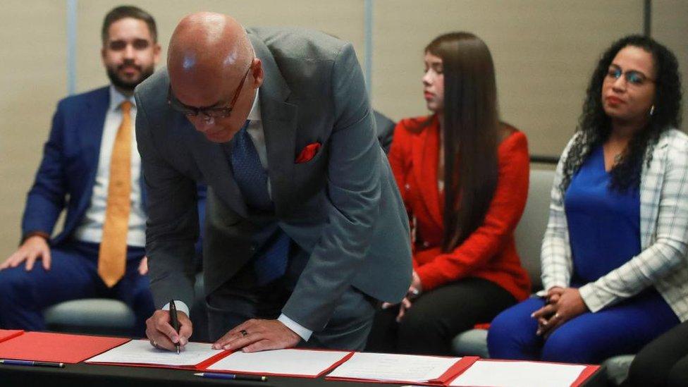 President of the National Assembly of Venezuela Jorge Rodriguez signs a preliminary agreement during talks in Mexico City, Mexico