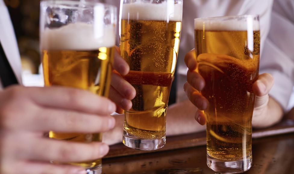 People drinking beer in a pub