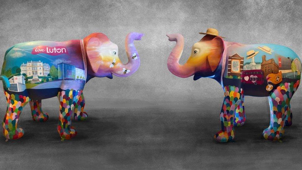 The front and back of a painted elephant statue called Sunrise