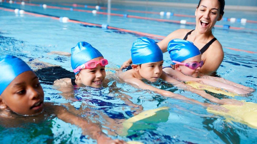 children's swimming lesson in pool