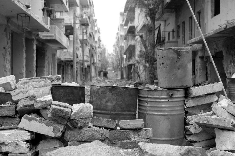 Barricade on abandoned street in eastern Aleppo