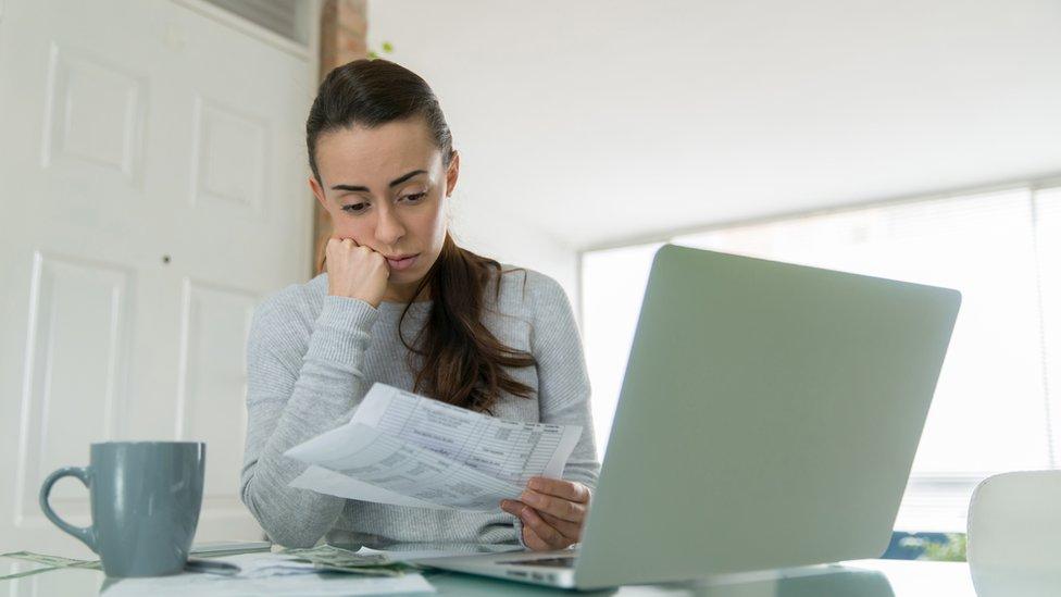 Woman looking at bills