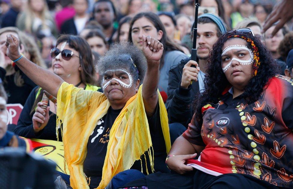 Protesters take part in a traditional smoking ceremony at the intersection of Swanston and Flinders street on April 10, 2015 in Melbourne, Australia. The gathering is part of ongoing protests against government plans to close down remote indigenous communities in Western Australia.