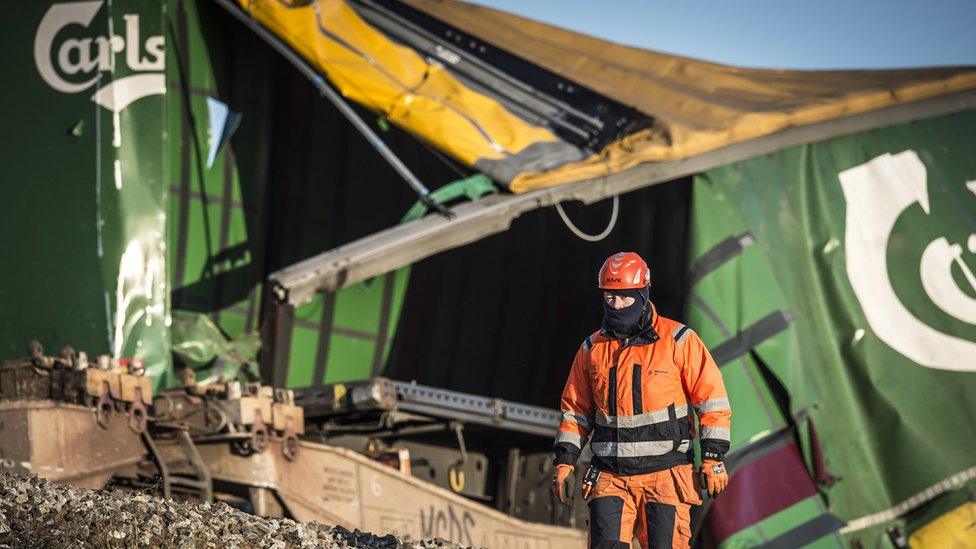 A member of the Danish emergency services at the scene following a train accident where six passengers died and at least 16 were injured at the Great Belt bridge between the Danish islands of Zealand and Funen, 02 January 2019.