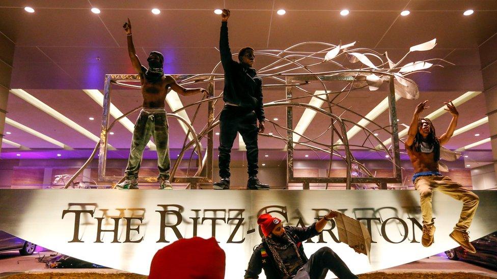 People gather in front of the Ritz-Carlton in uptown Charlotte, NC during a protest of the police shooting of Keith Scott, in Charlotte, North Carolina, U.S. September 21, 2016