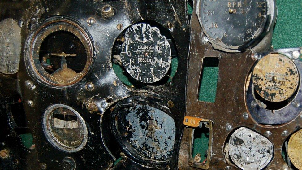 Part of the plane's battered dashboard with a number of badly-damaged gauges