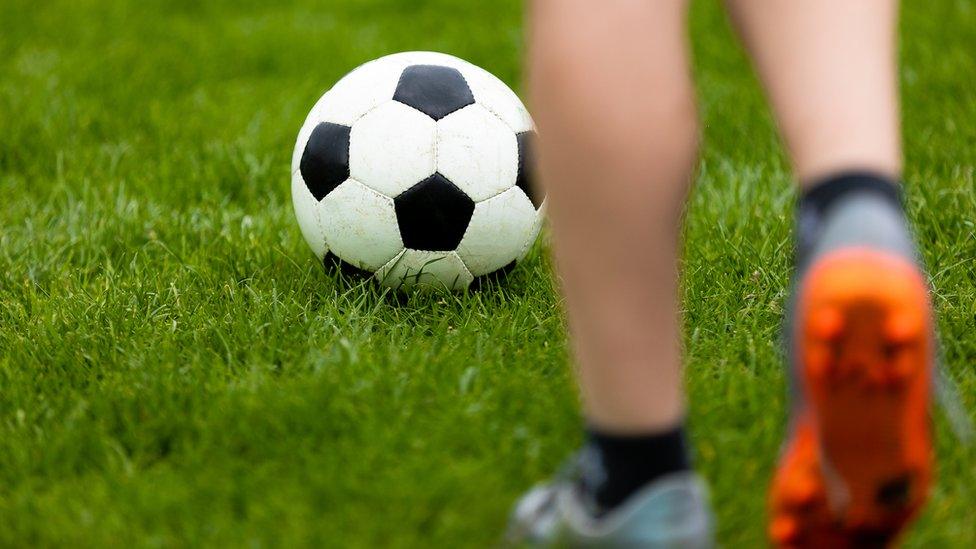 Child playing football