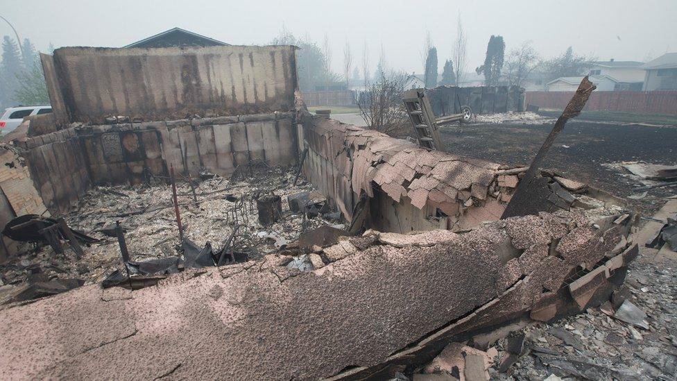 Home foundations and skeletons of possessions are all that remain in parts of a residential neighborhood destroyed by the wildfire (07 May 2016)