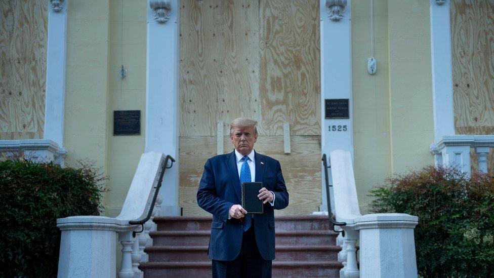 US President Donald Trump holds a Bible while visiting St John's Church across from the White House