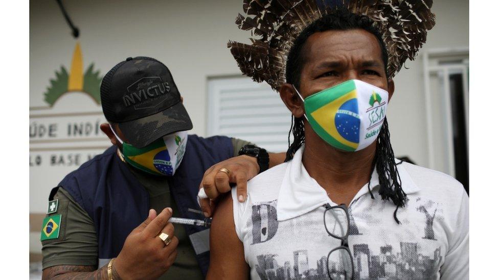 Health agent of the Special Indigenous Sanitary District of Manaus administers a coronavirus vaccine against a native of the Makira village, of the Mura ethnicity on the banks of the Urubu river in Itacoatiara, Amazonas, February 13, 2021