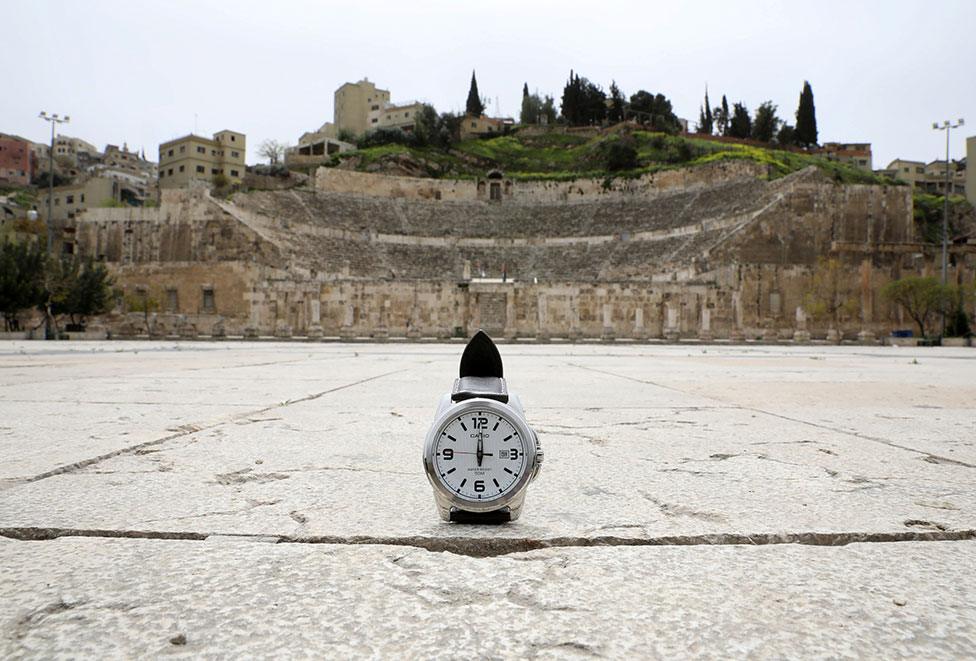 A watch showing the time at noon in front of the Roman theatre in Amman, Jordan