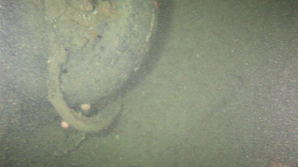 An underwater image showing a plane wheel