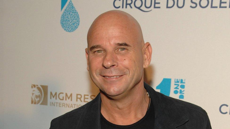 Guy Laliberté smiles at a Cirque du Soleil event