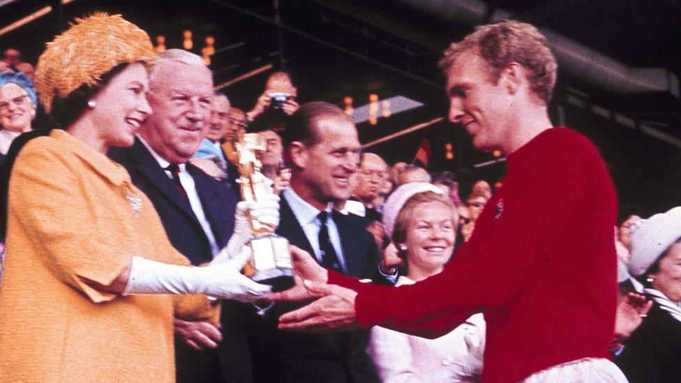 The Queen, patron of the FA, presents the World Cup, the Jules Rimet trophy, to England's team captain Bobby Moore in July 1966