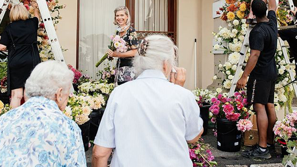 Residents at the Huis Vergenoegd Old Age Home in Paarl, South Africa looking at the flowers