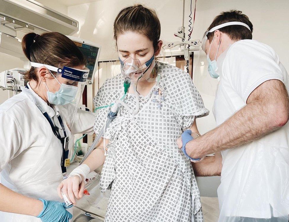 Dr Catherine McCarroll is helped up by medics after her double lung transplant