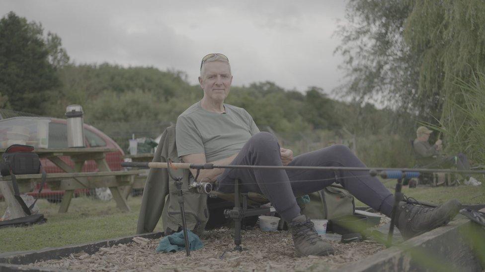 Nick Buck sitting in a chair fishing