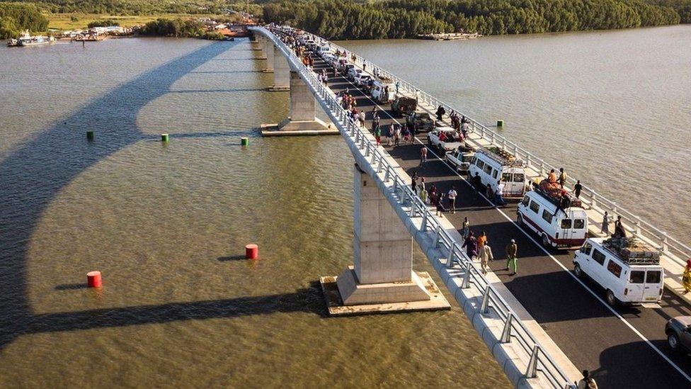 Aerial view of people crossing the Farafenni Bridge after its inauguration by Senegal's president and Gambia's President on 21 January 2019, in Farafenni