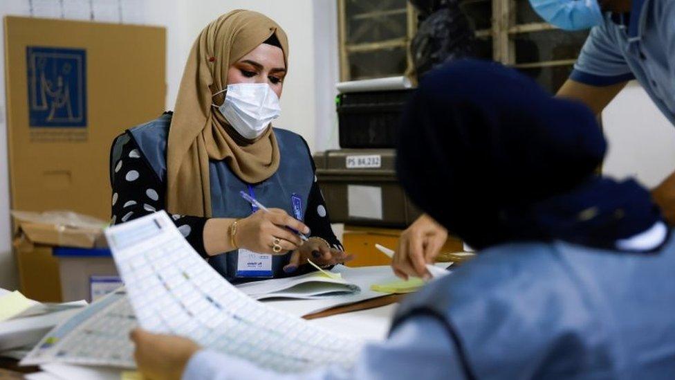 Officials work at a polling station during the Iraqi parliamentary election, in Baghdad (10 October 2021)