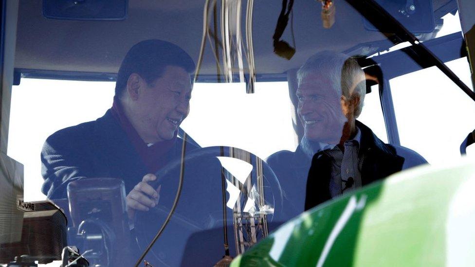 Xi Jinping talks with Rick Kimberley as they sit in the cab of a tractor