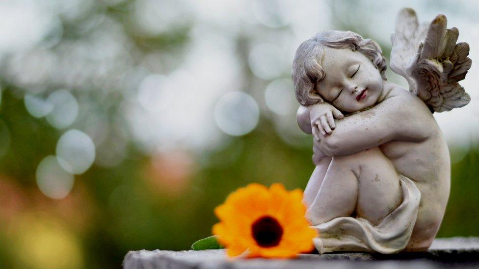 Angel guardian sleeping on a grave