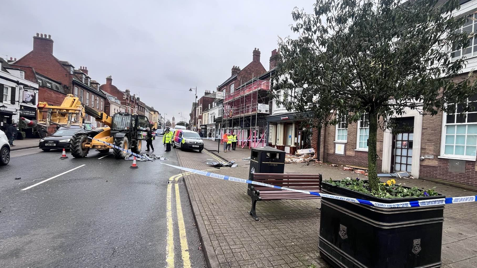 Digger and police tape outside ram-raided Nationwide building society branch on Newmarket High Street