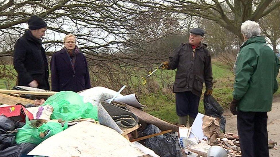 Villagers at fly-tipping site