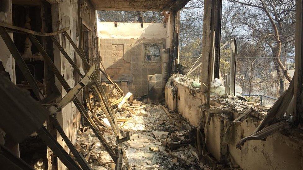 A burnt out building following wildfires in Greece