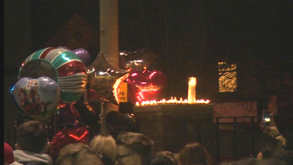 Balloons and flowers at vigil