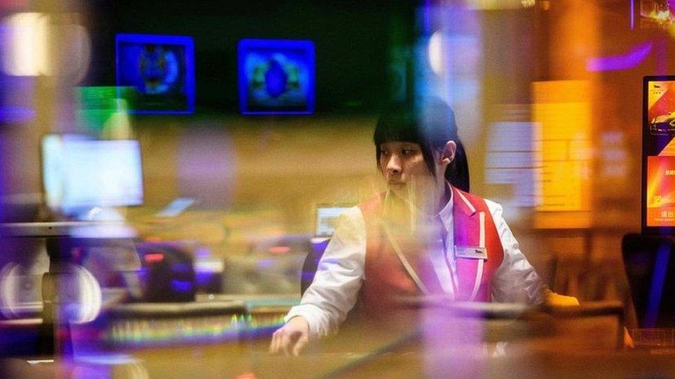 A member of staff prepares for the opening of a casino in Macau