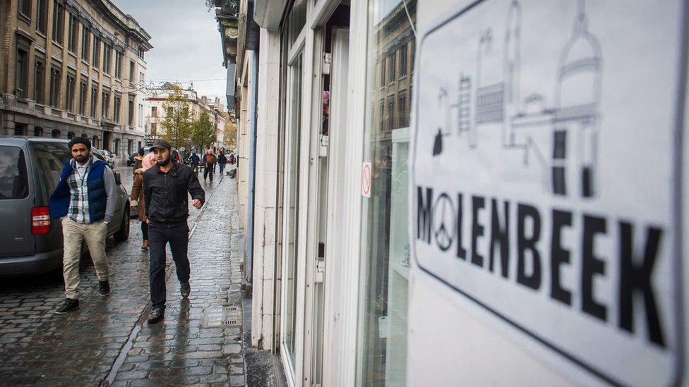 Two men walk in a street of Molenbeek, a municipality of Brussels, Belgium, 17 November 2015.