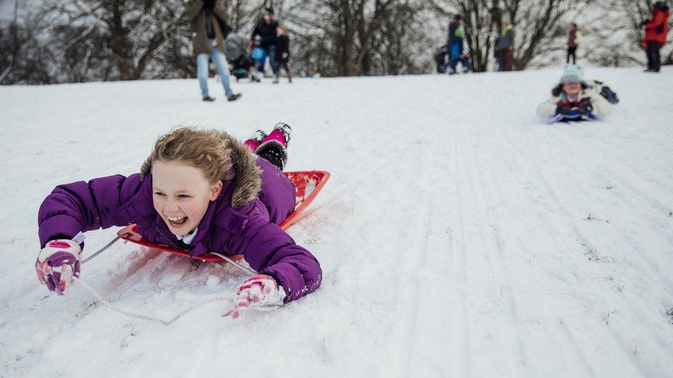 Kids sledging in the snow