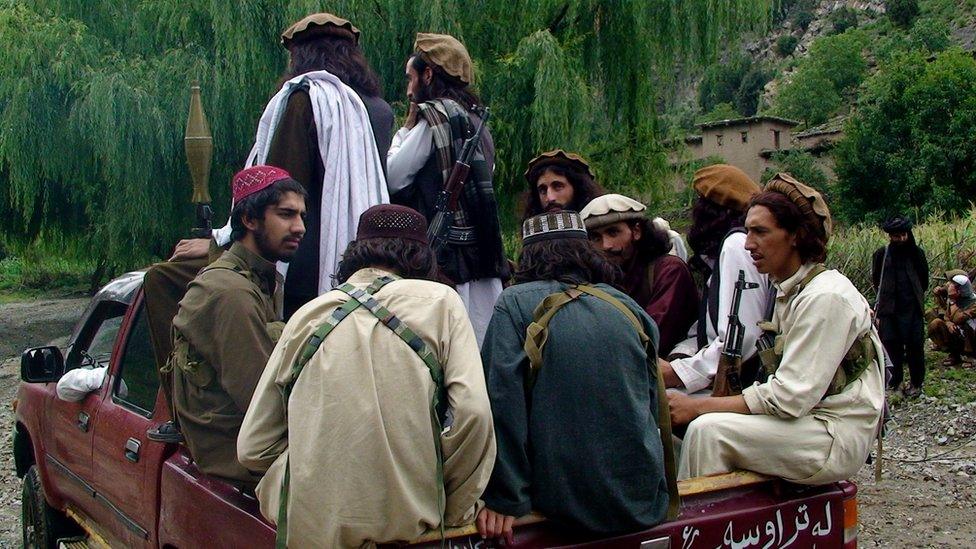 Taliban patrol in their stronghold of Shawal in Pakistani tribal region of South Waziristan